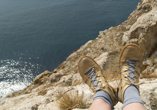 Feet hanging off a cliff